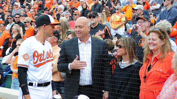 Apr 3, 2017; Baltimore, MD, USA; Baltimore Orioles infielder Ryan Flaherty (L) talks to former shortstop Cal Ripken, Jr. (C) prior to the game against the Toronto Blue Jays at Oriole Park at Camden Yards.